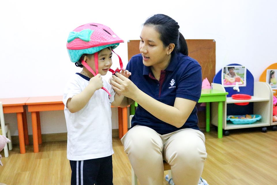 Bé học cách đội nón bảo hiểm