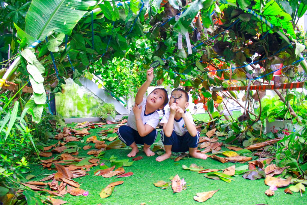 Kindy City students playing under hand-made branches